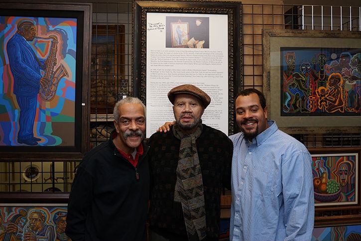 Three men taking picture