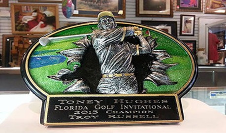 A decorative plaque showcasing a golf player mid-swing