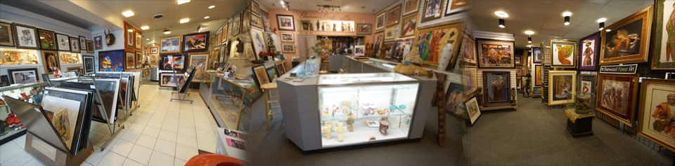 A spacious gallery filled with numerous paintings displayed on the walls