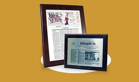 A framed newspaper and a framed picture